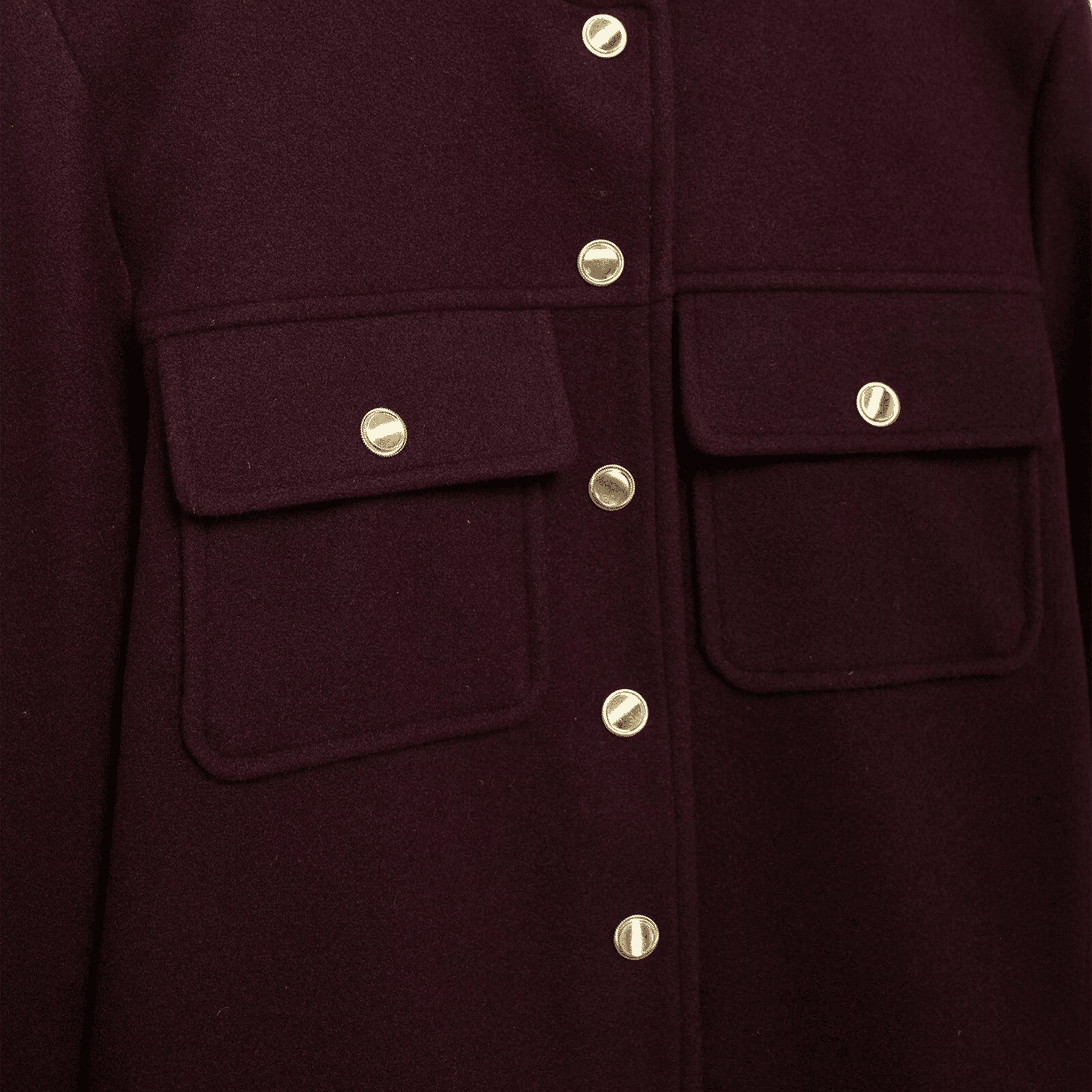 Close-up of a dark purple coat with gold buttons on a dark background