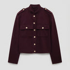 Maroon jacket with gold buttons on a light gray background