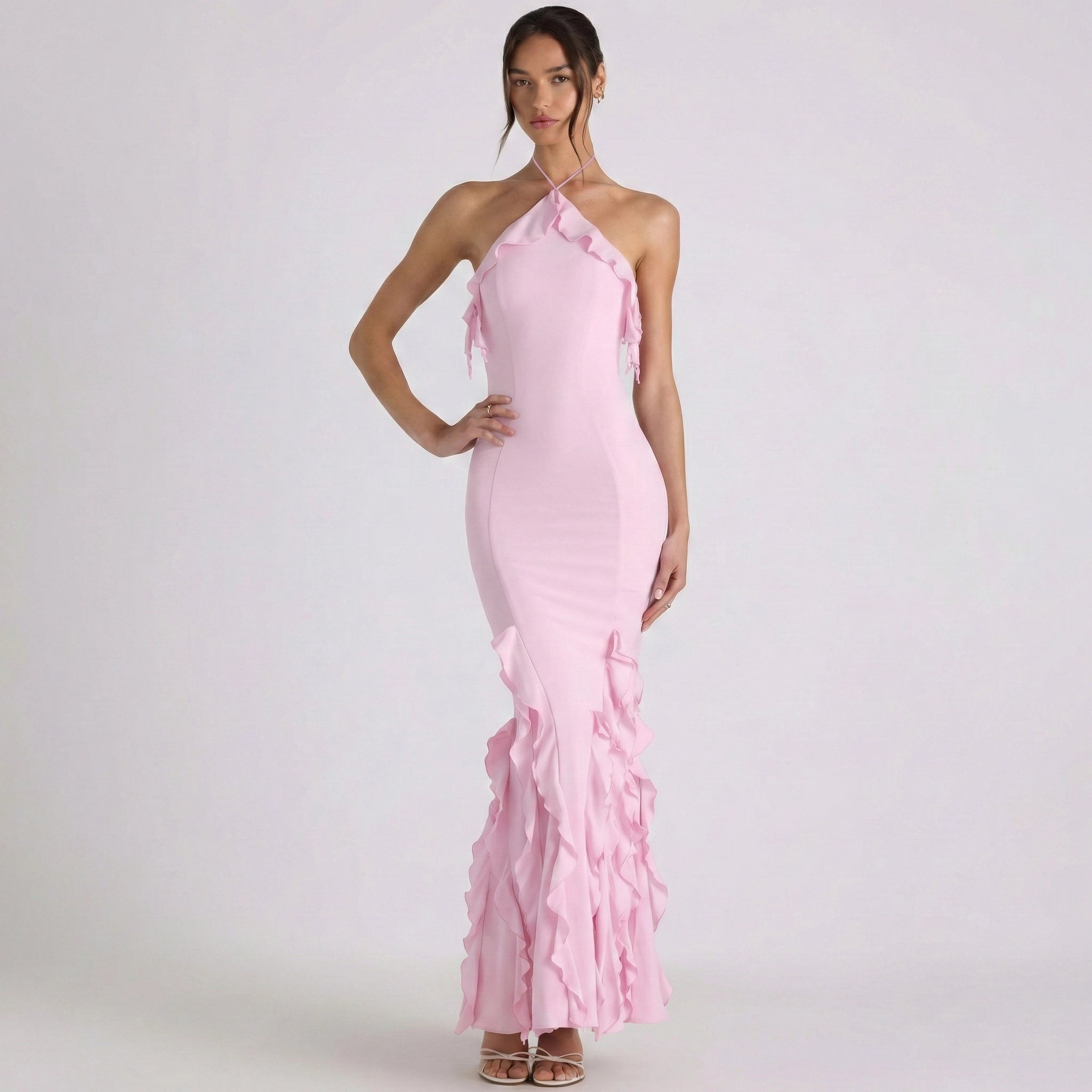 Pink halter neck dress with ruffles on a white background
