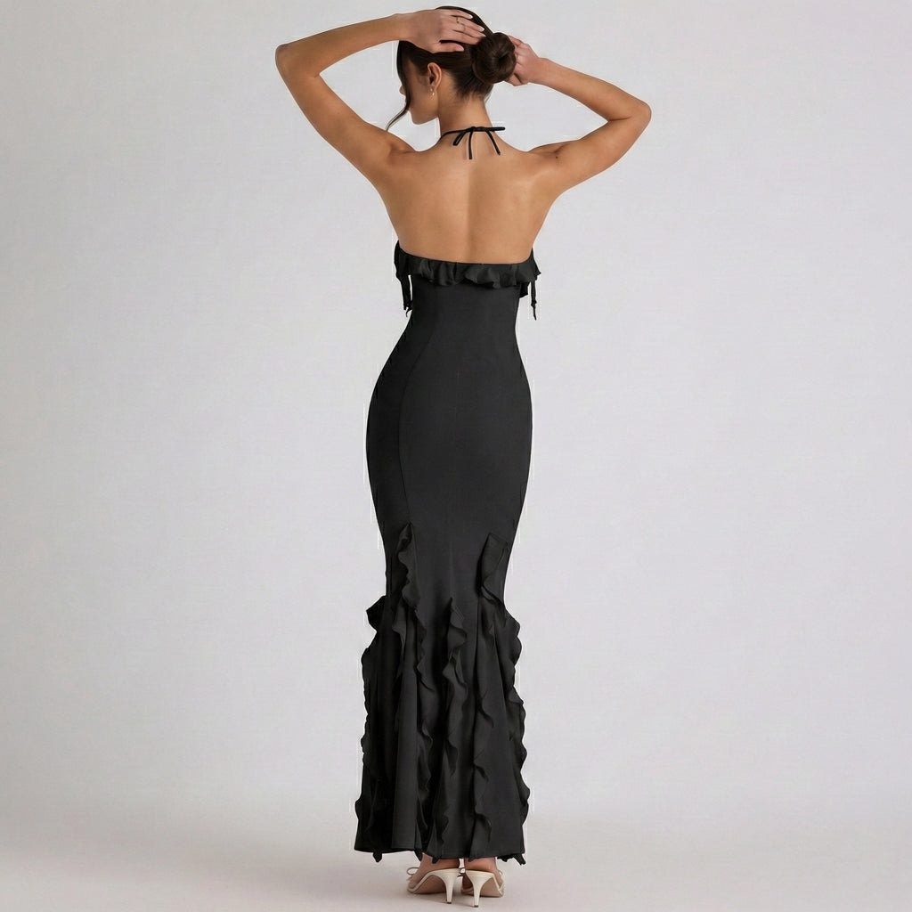 Black evening gown with ruffled details on a white background