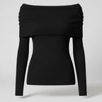 Black off-shoulder sweater on a light gray background