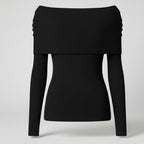 Black off-shoulder sweater on a light gray background