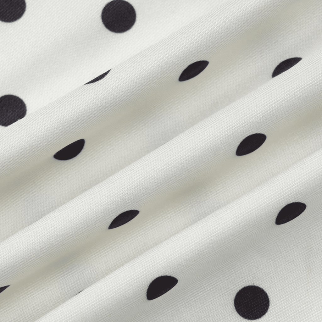 Close-up of white fabric with black polka dots