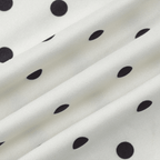Close-up of white fabric with black polka dots