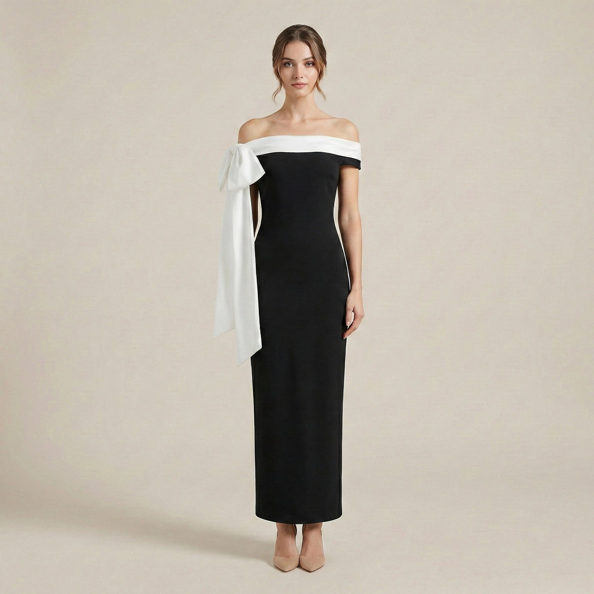 Woman wearing a black and white off-shoulder dress on a beige background