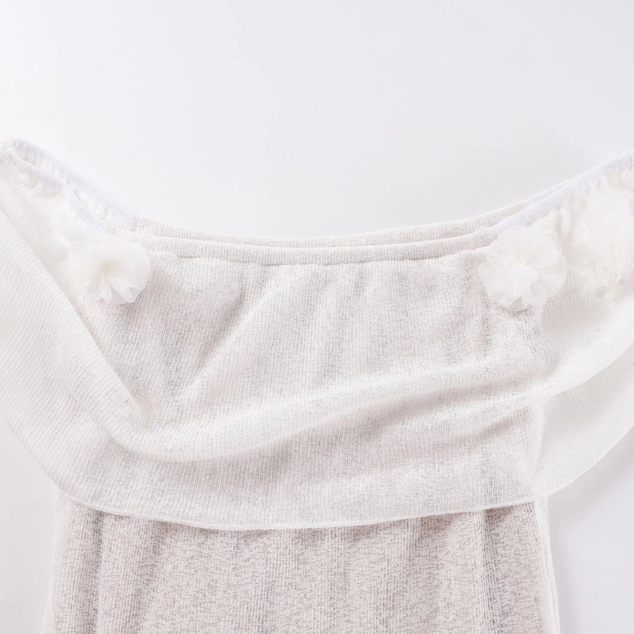 Close-up of a textured white fabric on a light gray background