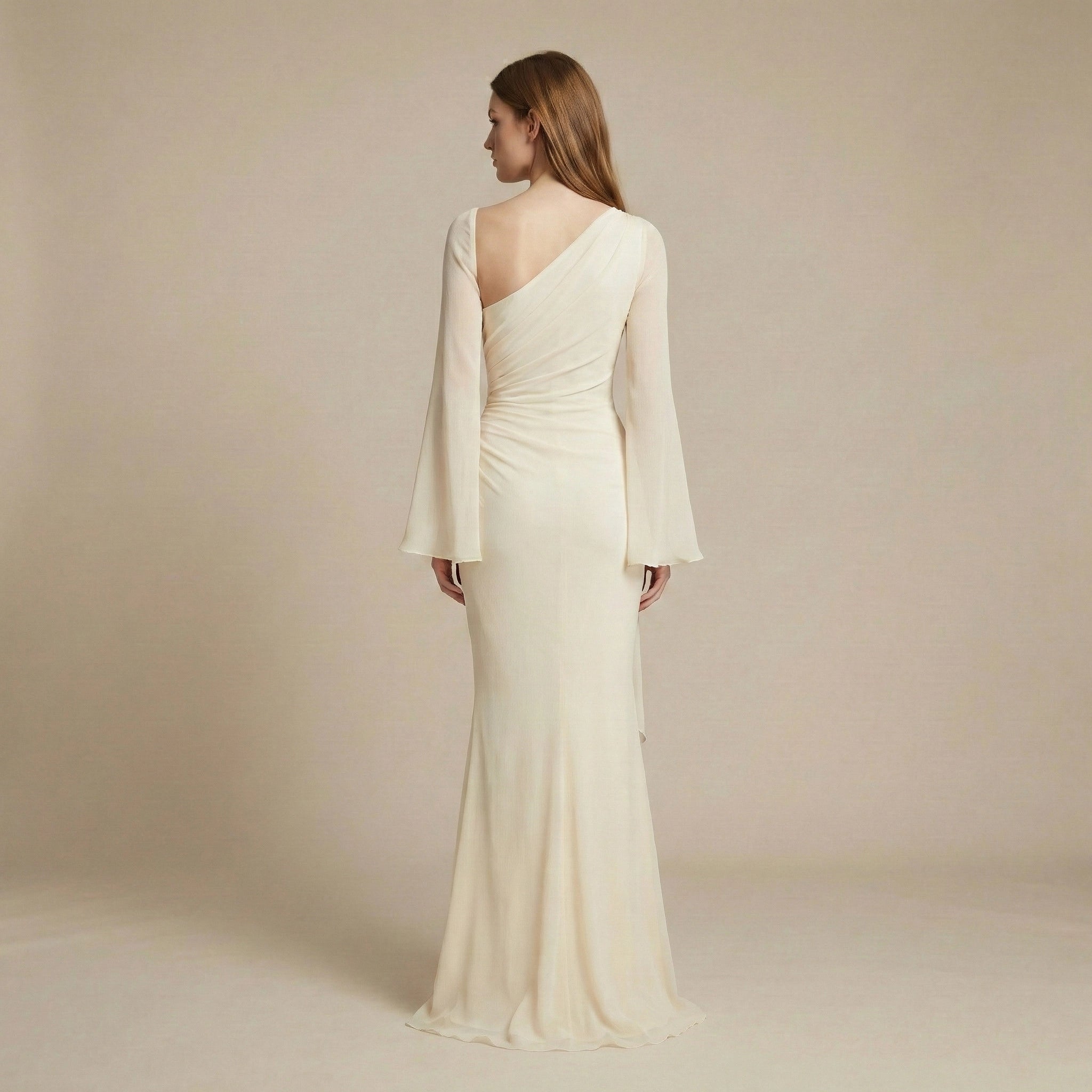 Woman wearing a one-shoulder white gown with long sleeves on a beige background
