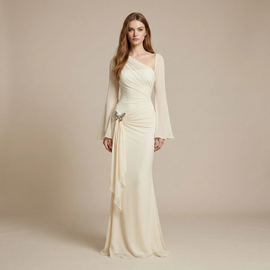Woman wearing a long, elegant cream dress with a matching jacket against a beige background
