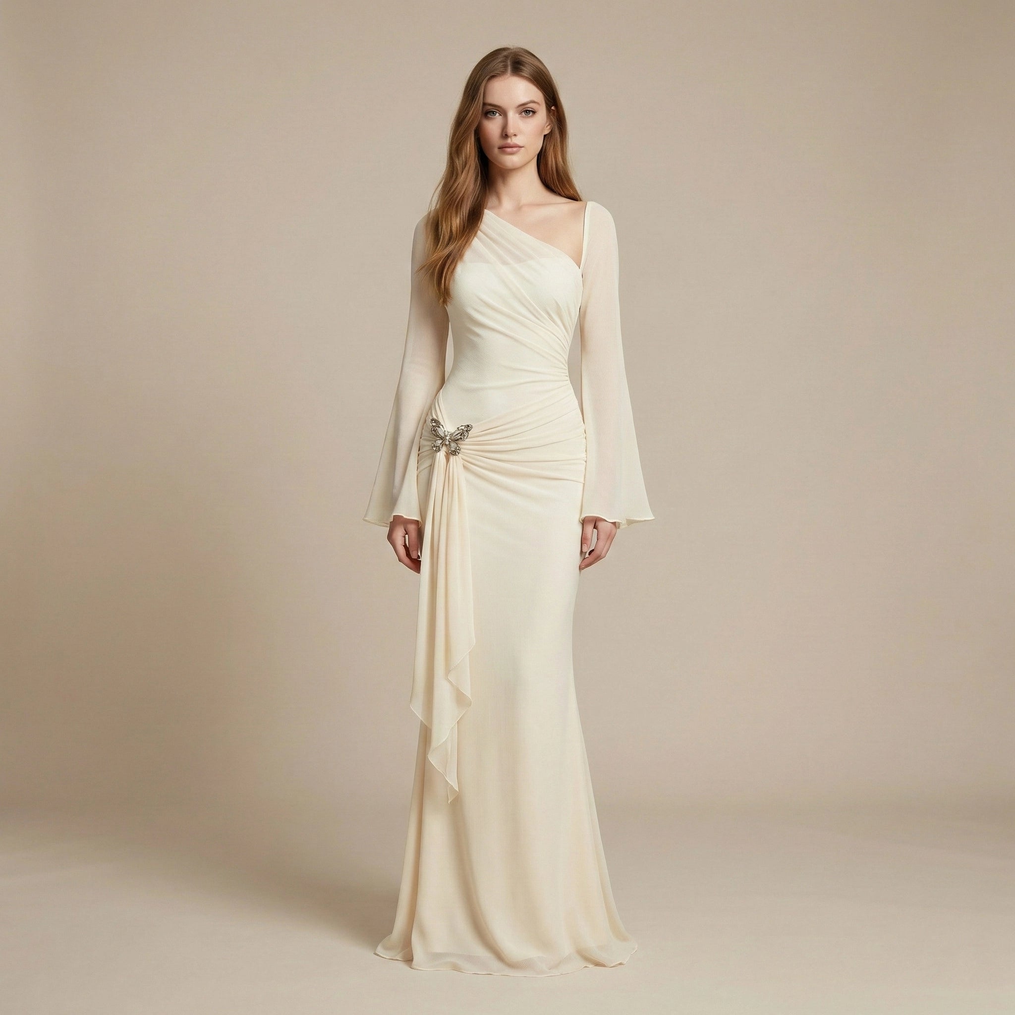 Woman wearing a long, elegant cream dress with a matching jacket against a beige background