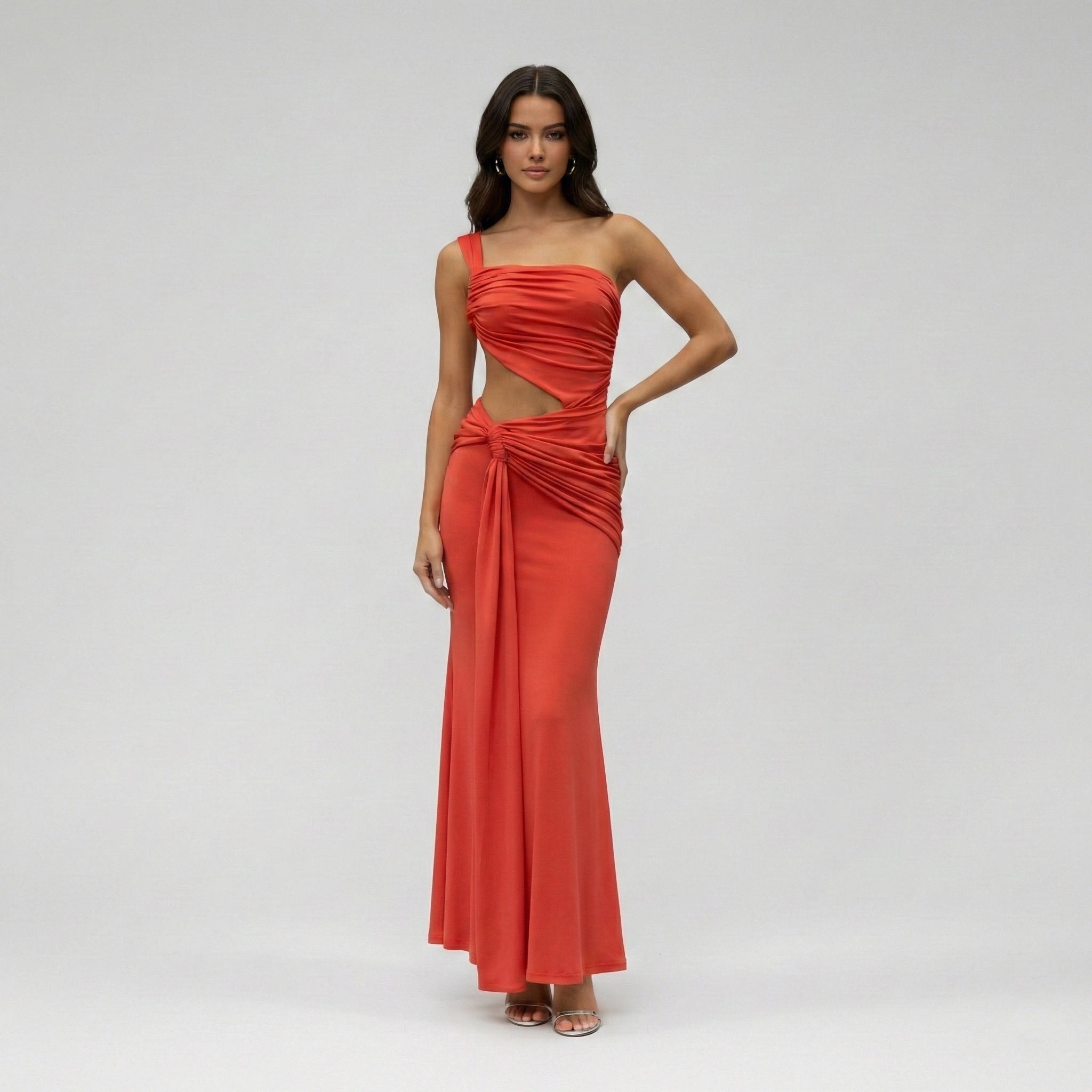 Woman wearing a red evening gown on a gray background