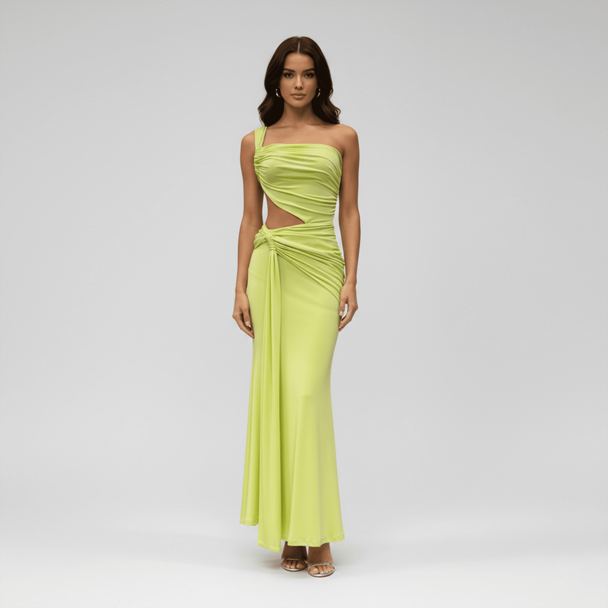 Woman wearing a strapless green evening gown on a gray background