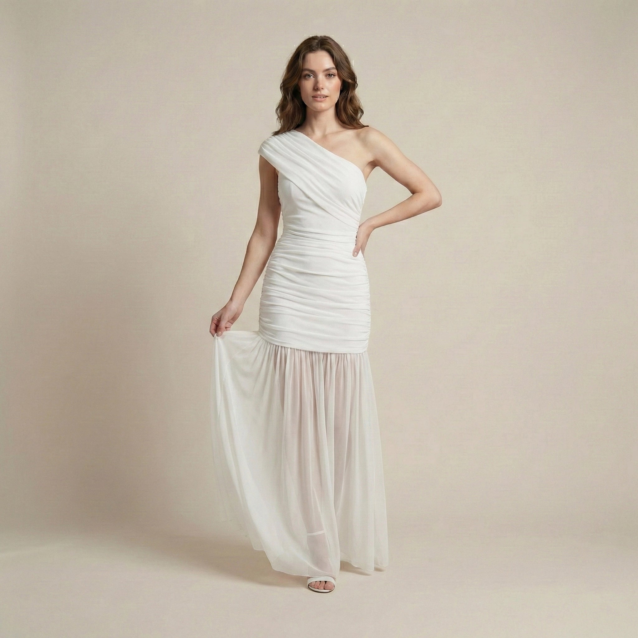 Woman wearing a white one-shoulder dress against a beige background