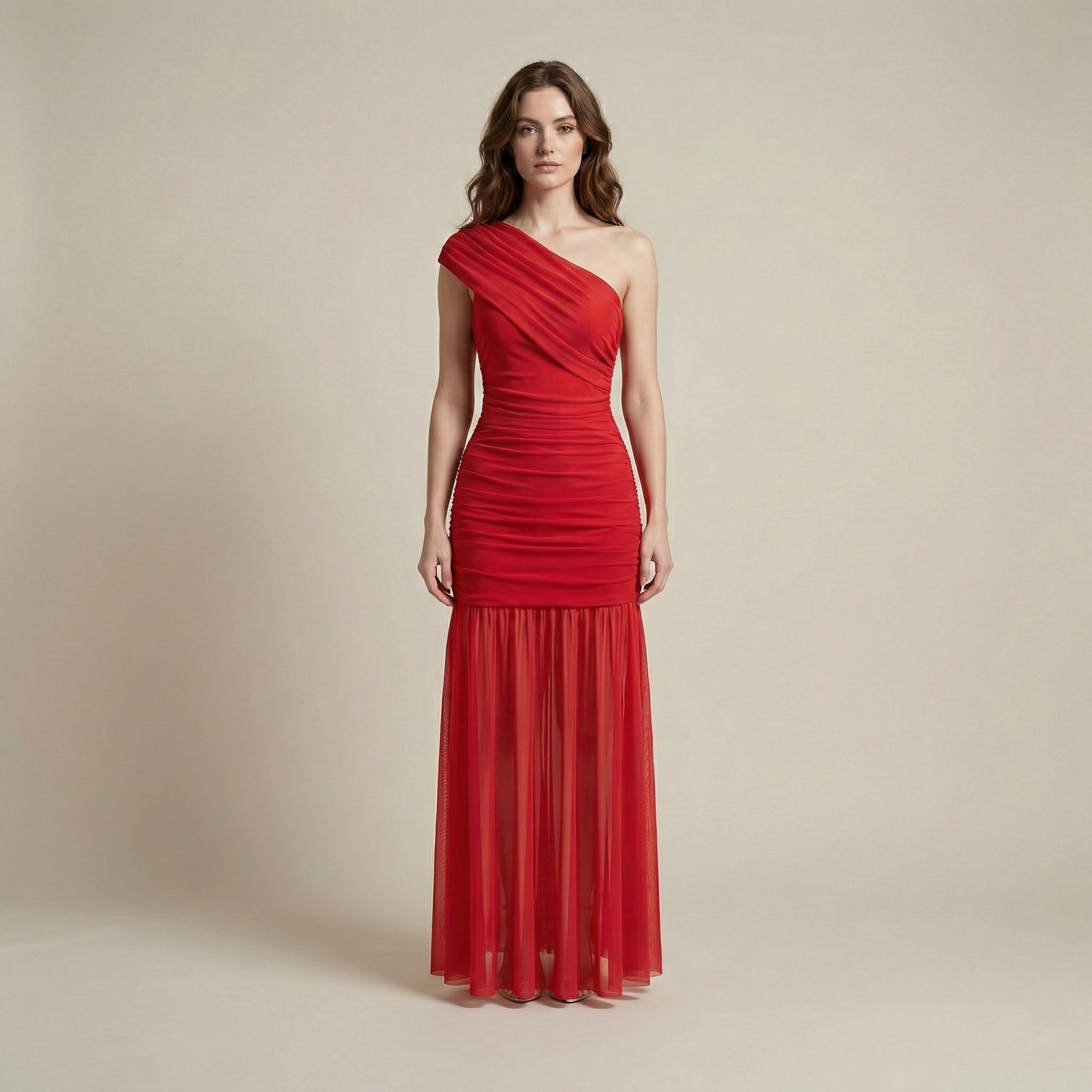 Woman wearing a red one-shoulder gown against a beige background