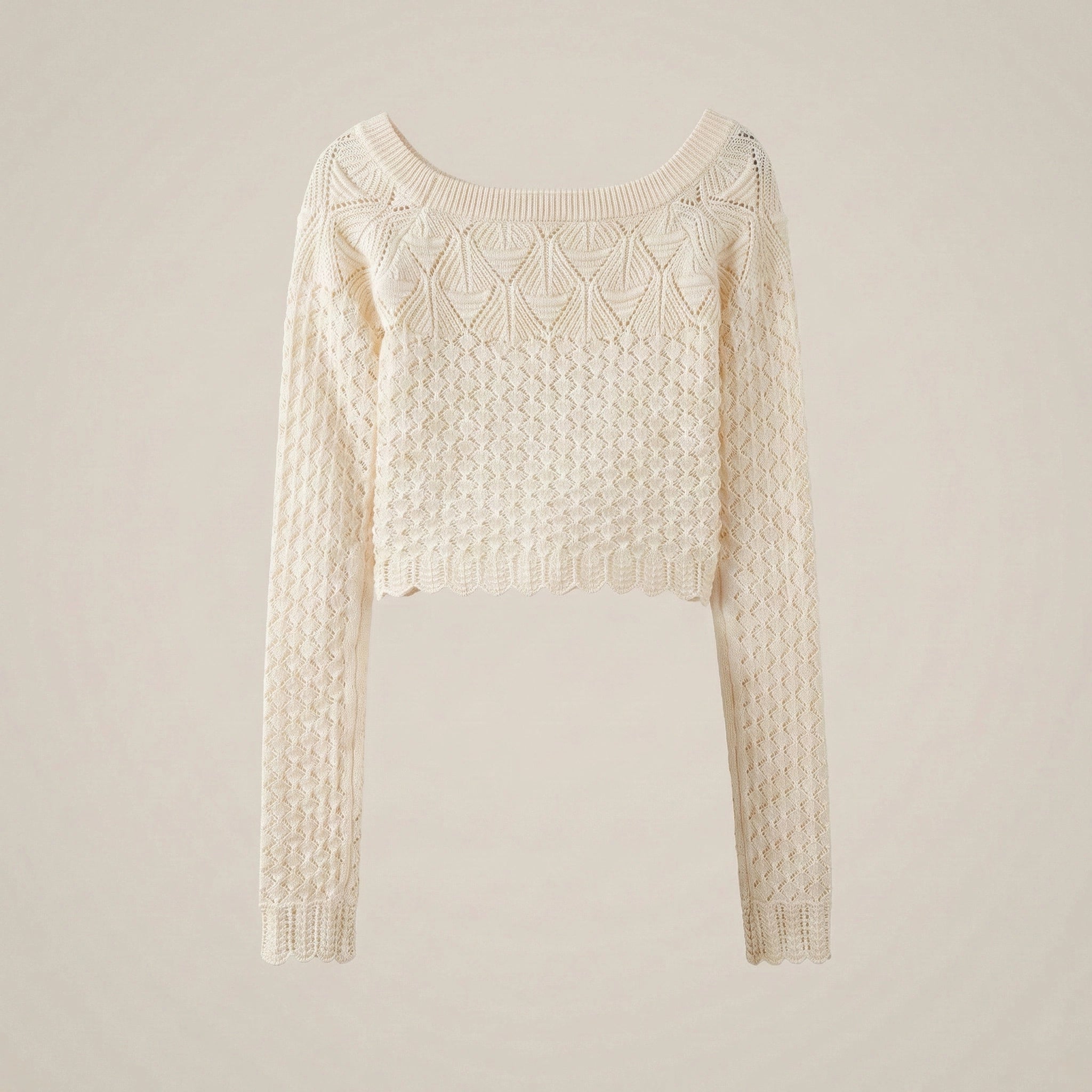 Cream-colored sweater with intricate pattern on a beige background