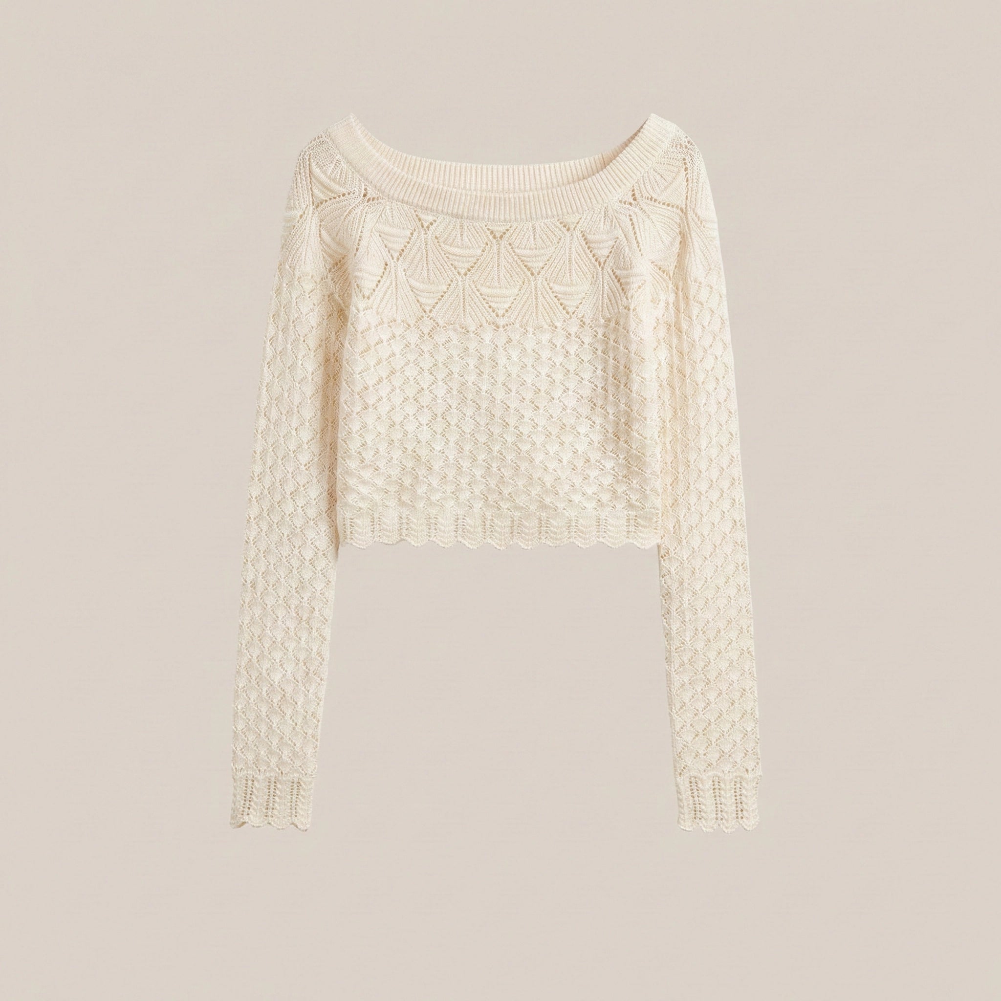Cream-colored sweater with intricate pattern on a light gray background