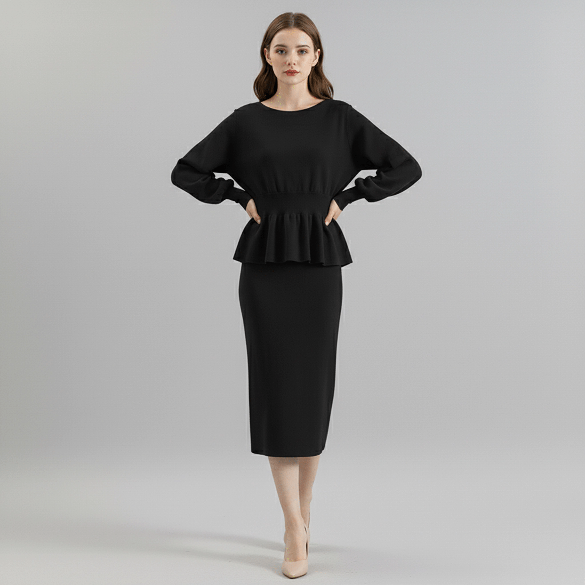 Woman wearing a black peplum top and pencil skirt on a gray background