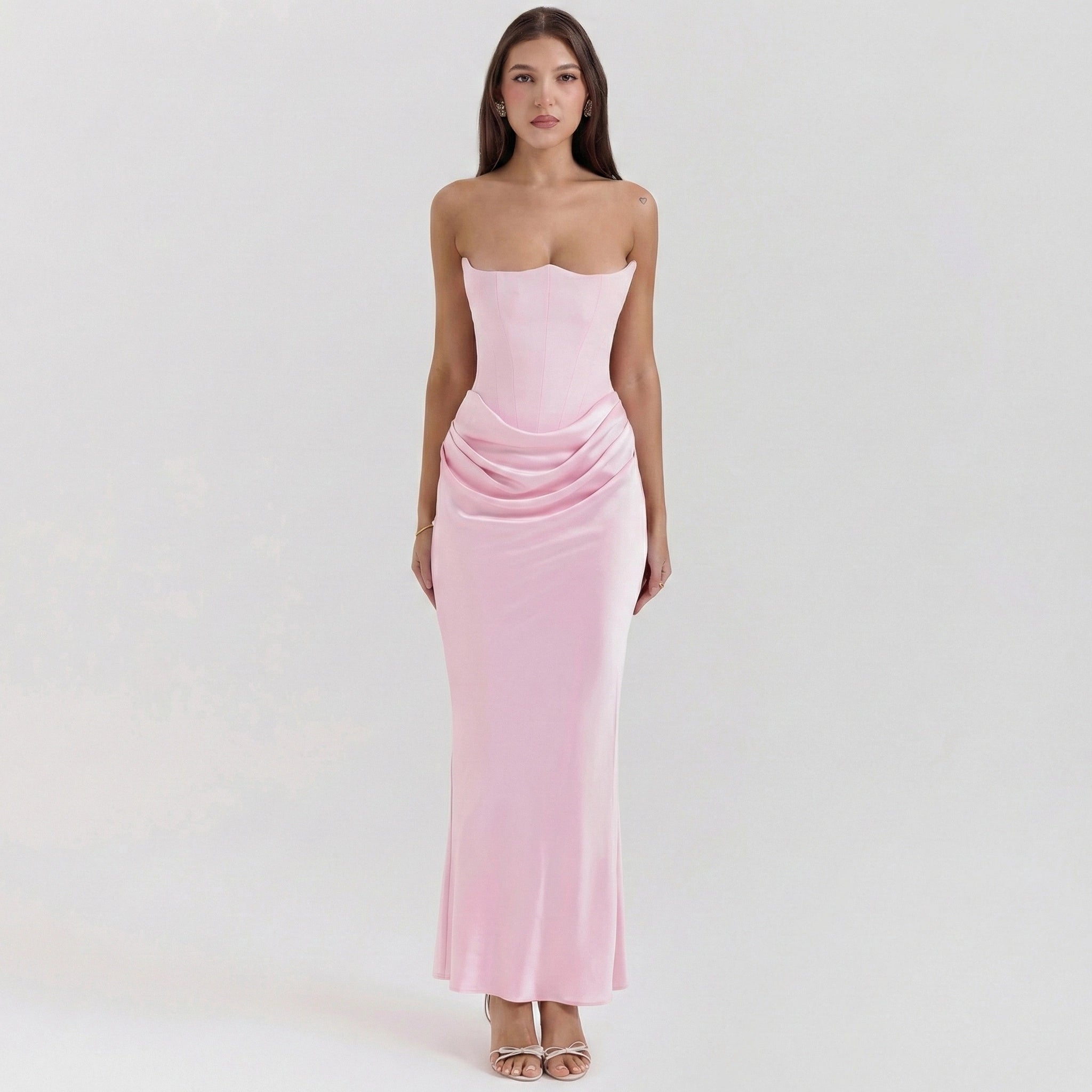 Woman wearing a pink strapless gown on a white background
