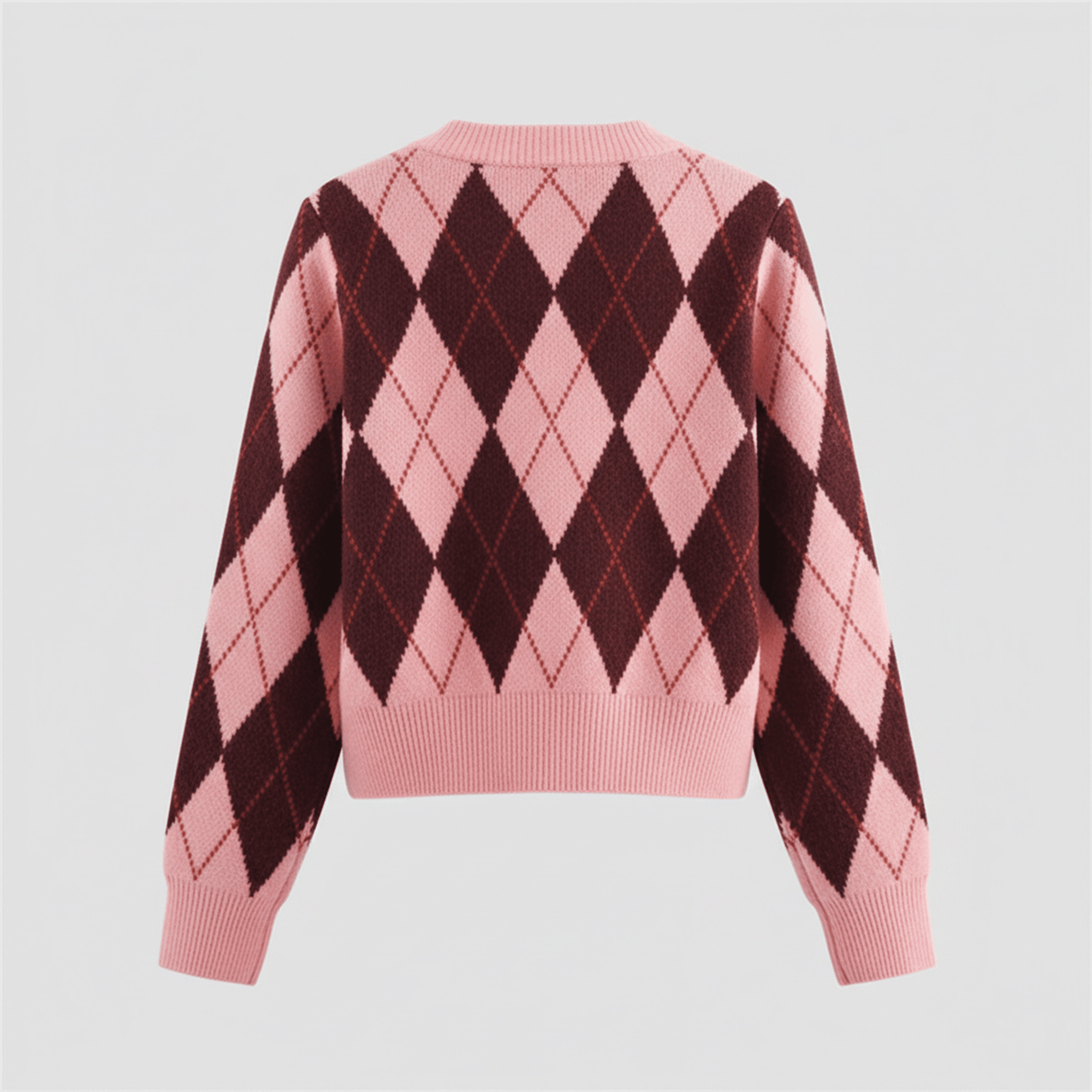 Pink and brown argyle pattern sweater on a light gray background