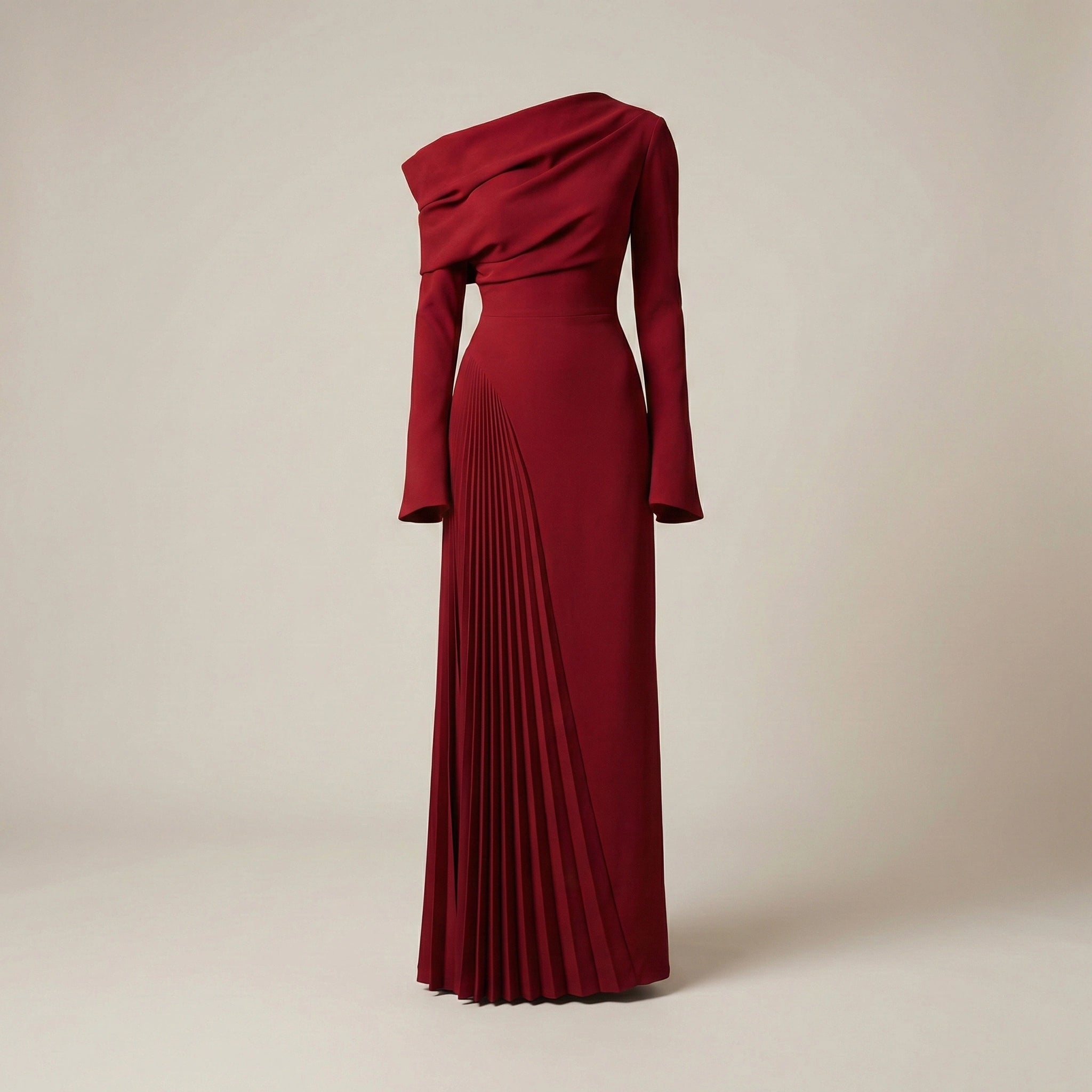 Red one-shoulder dress with pleated skirt on a beige background