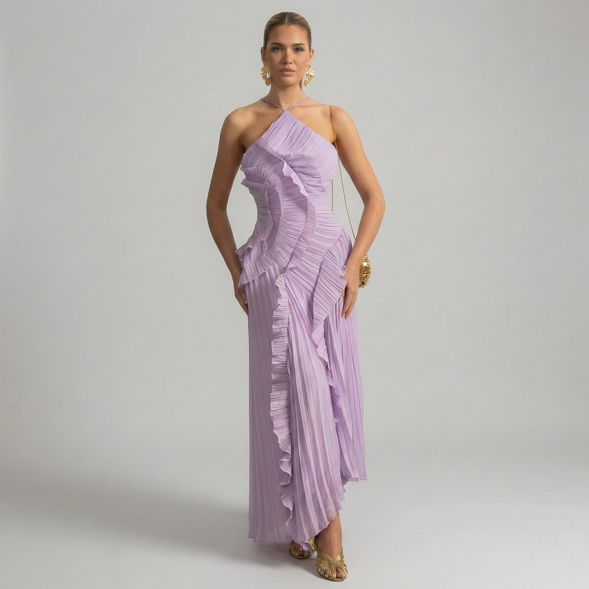 Woman wearing a one-shoulder lavender dress against a plain background