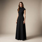 Woman wearing a black dress against a beige background