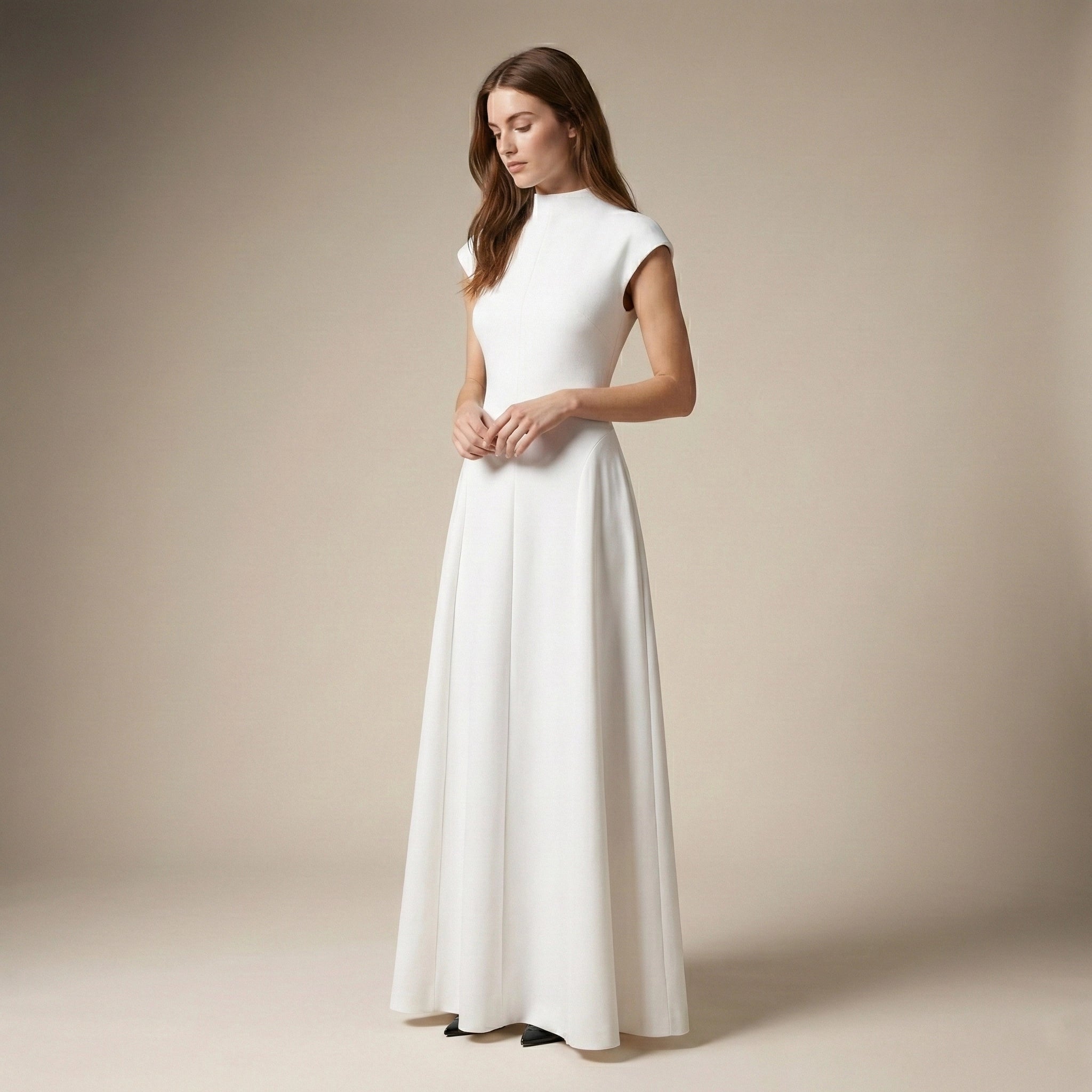 Woman wearing a white dress against a beige background