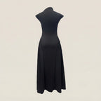 Black dress on a mannequin against a beige background