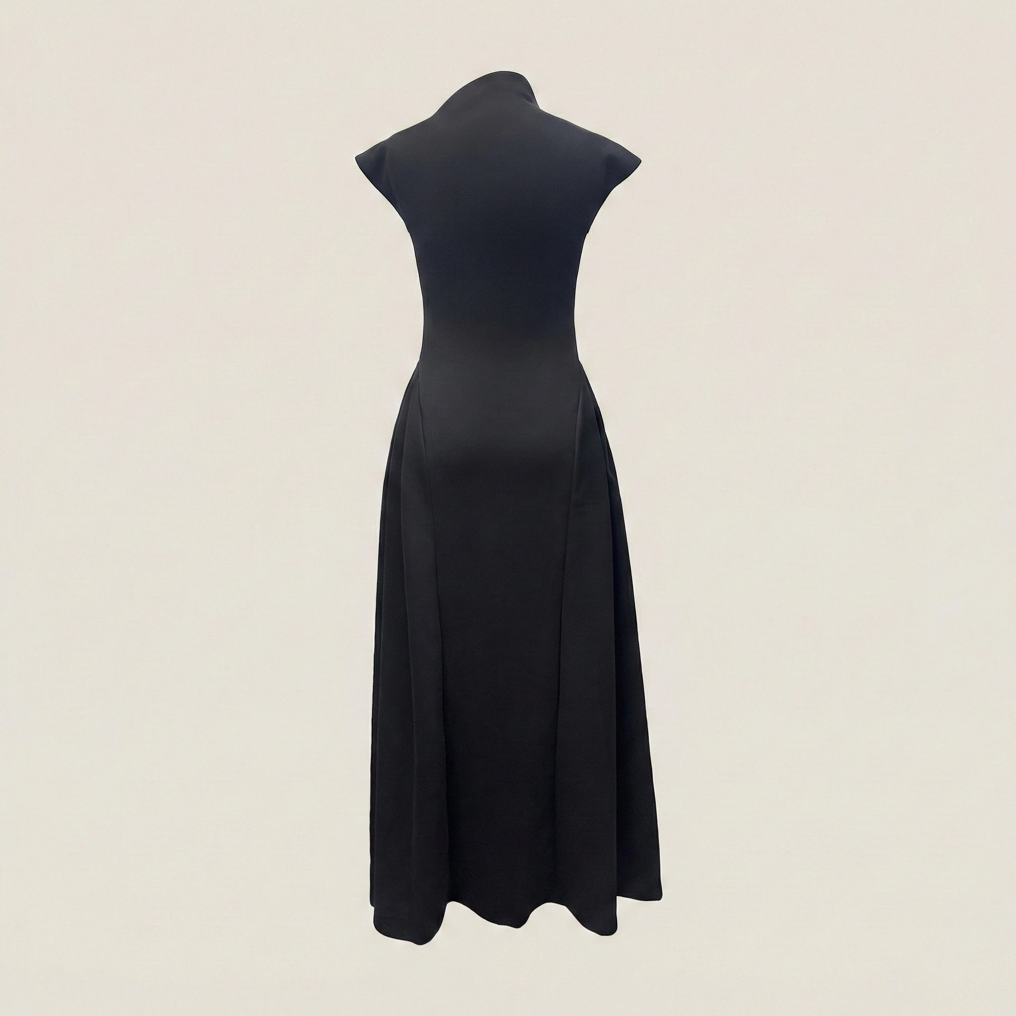 Black dress on a mannequin against a beige background
