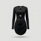 Black dress with gold buttons on a light gray background