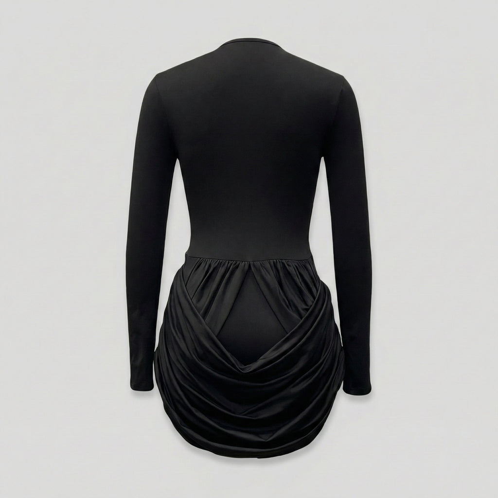 Black long-sleeve dress with a draped skirt on a light gray background
