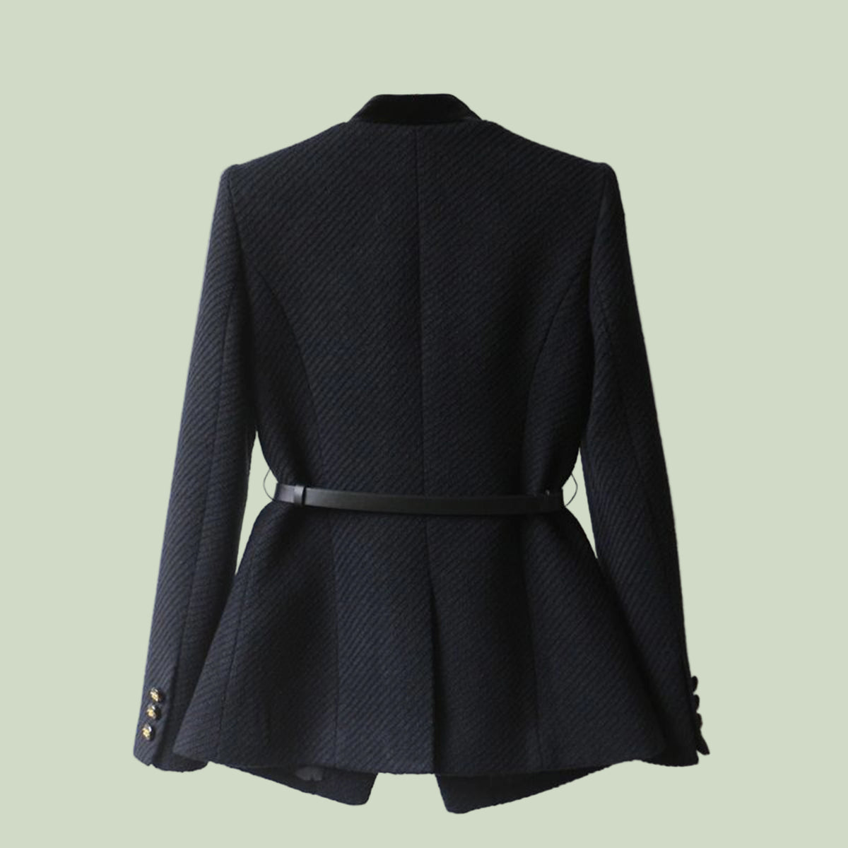 Black textured blazer with a belt on a light green background