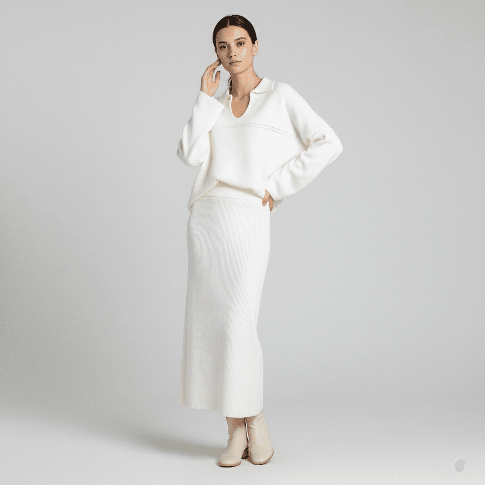 Woman wearing a white outfit on a plain background