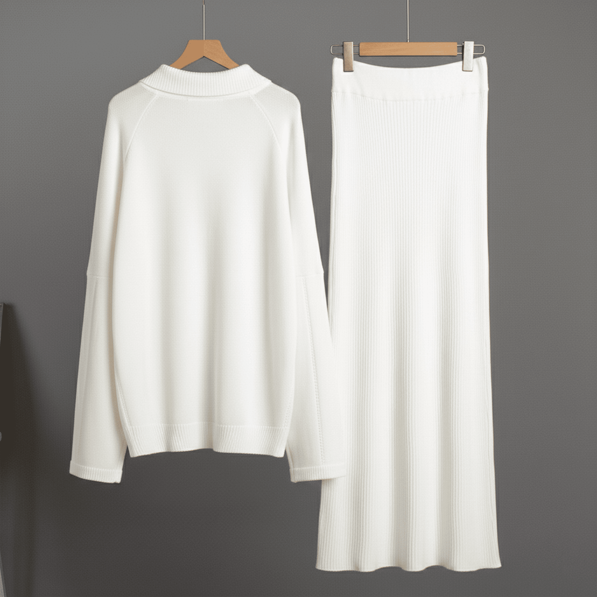 White long-sleeve top and wide-leg pants on hangers against a gray background