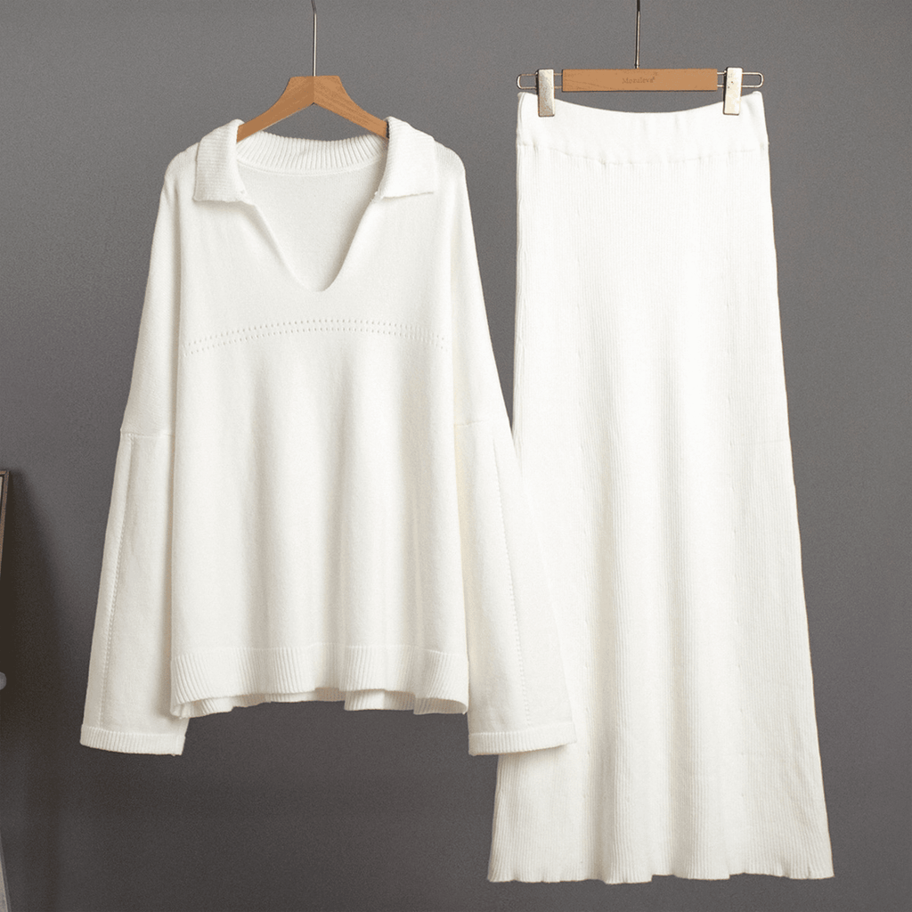 White long-sleeve top and skirt set on hangers against a gray background