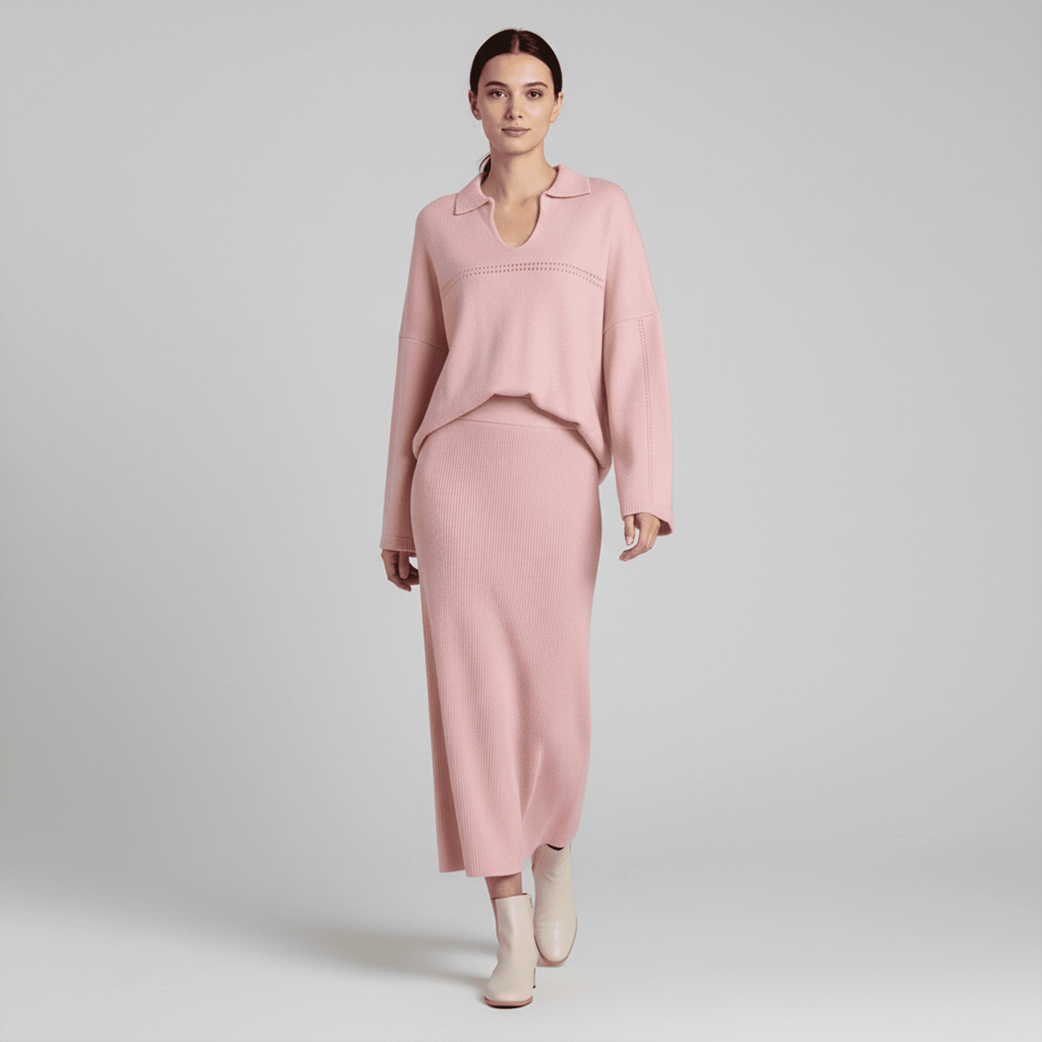 Woman wearing a pink outfit on a gray background