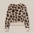 Leopard print sweater on a plain background