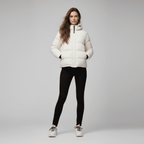Woman wearing a white puffer jacket on a gray background