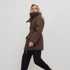 Woman wearing a brown coat on a white background