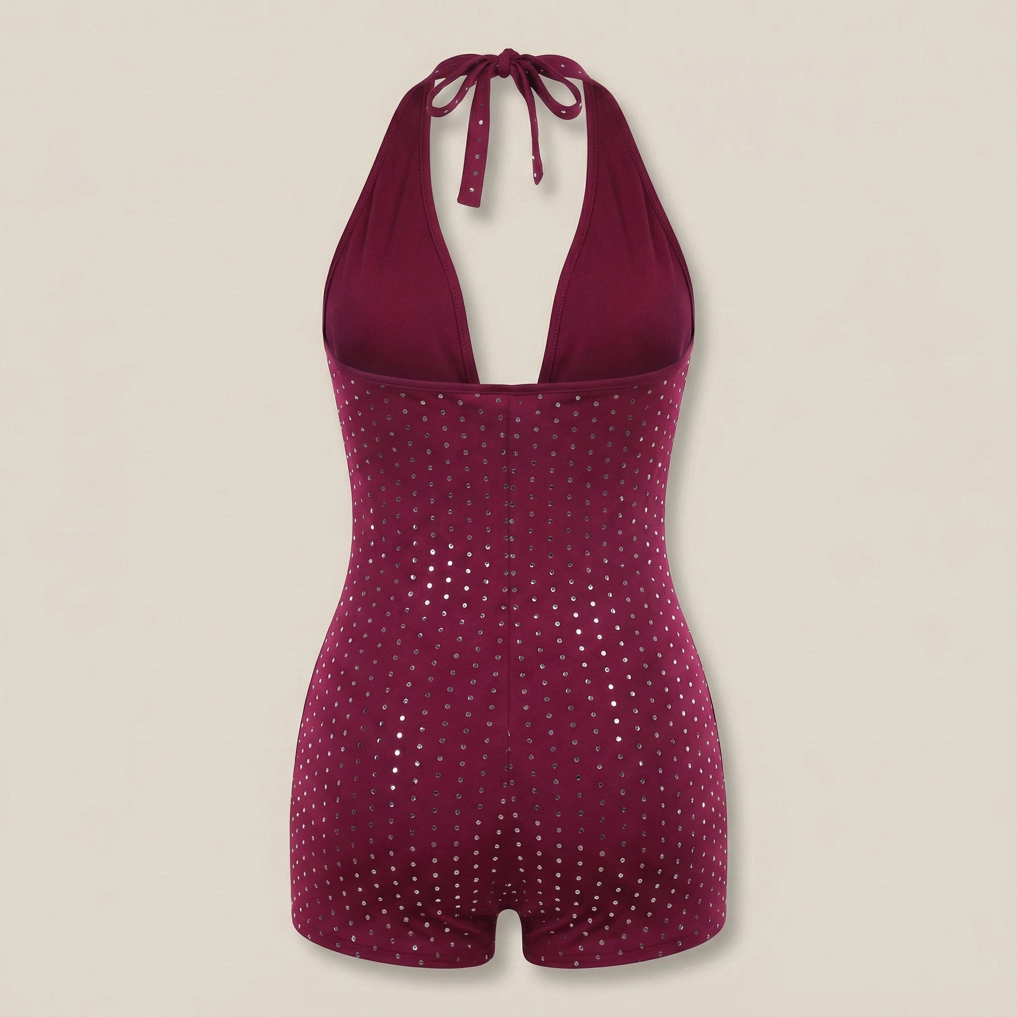 Magenta sequin swimsuit on a beige background