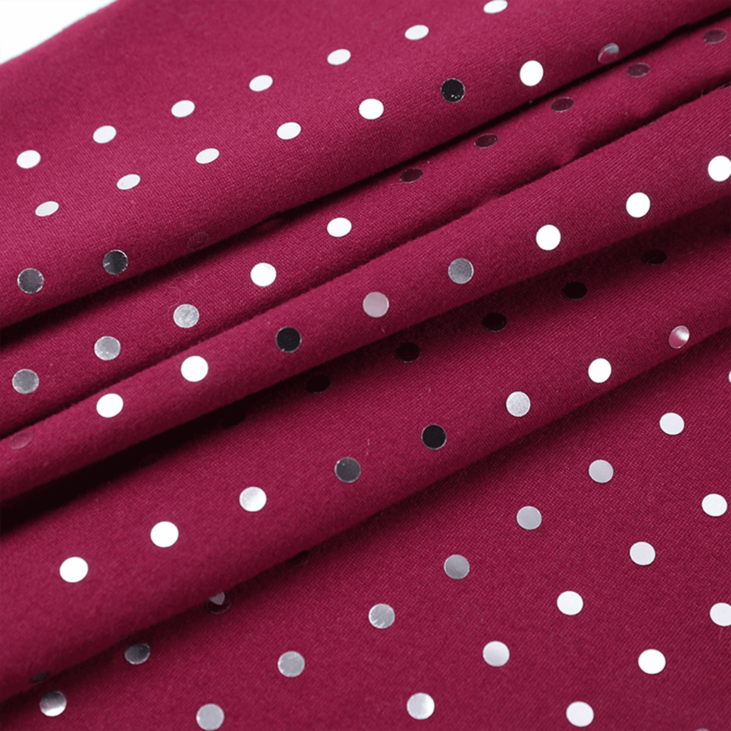 Red fabric with white polka dots and small black and gray spots