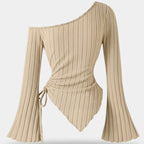 Beige ribbed long-sleeve top with flared sleeves on a light gray background