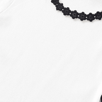 Black floral necklace on a white background