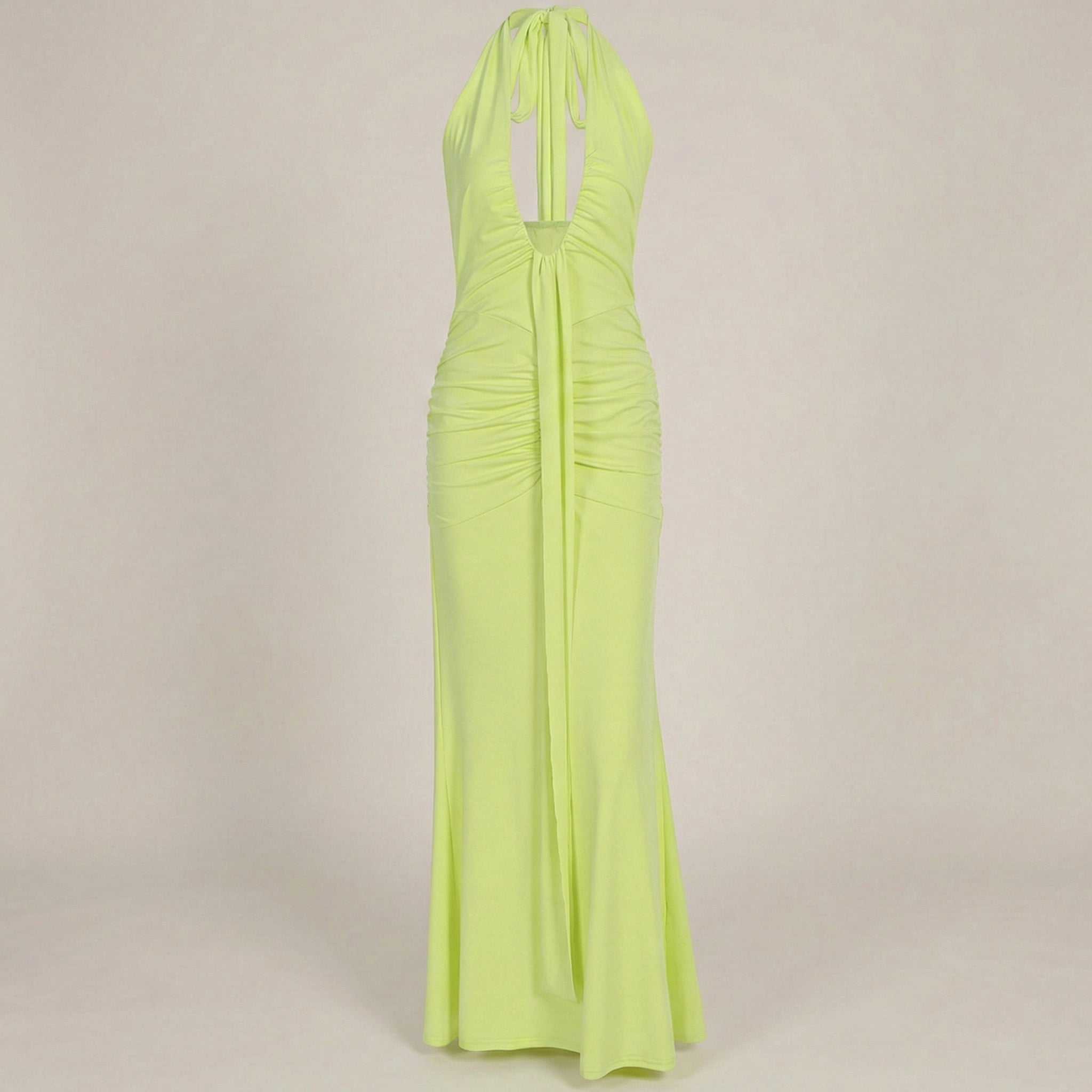 Lime green halter neck gown on a beige background