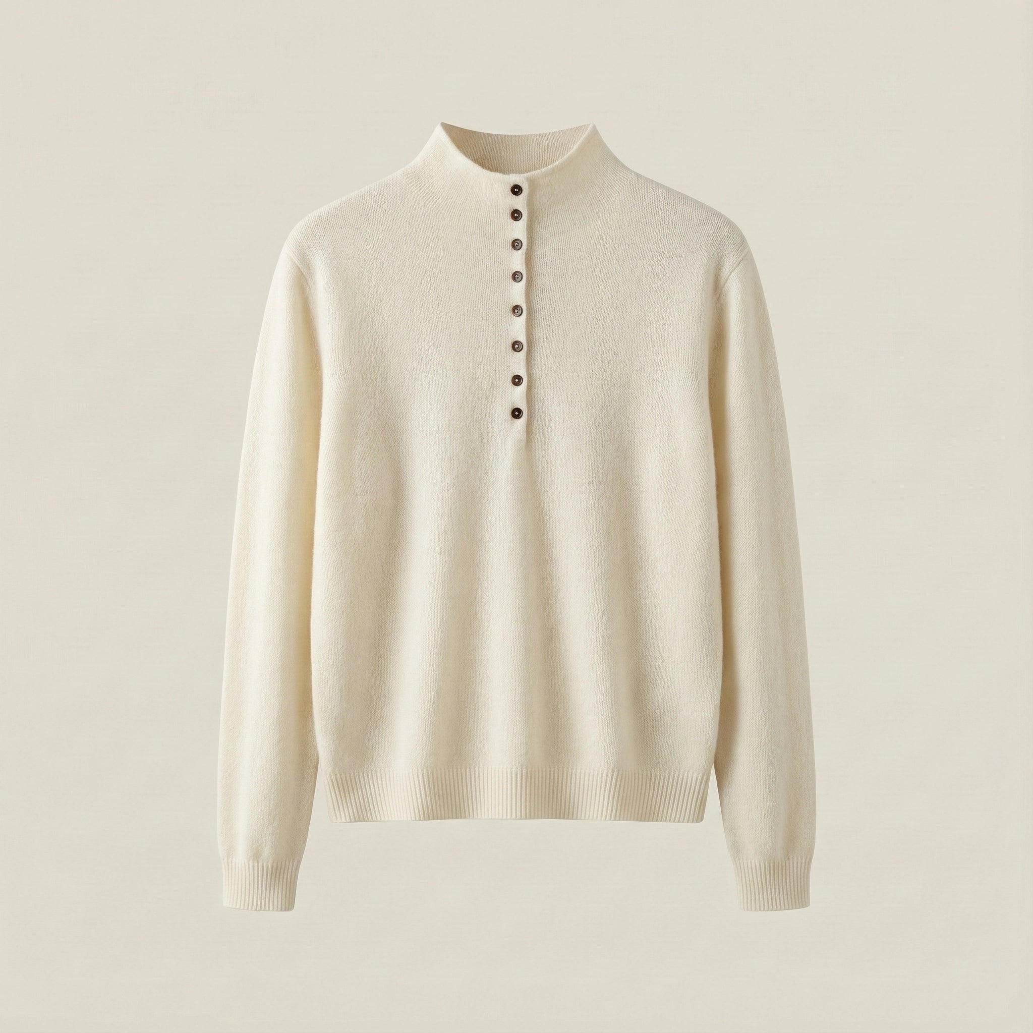 Beige sweater with button details on a light beige background