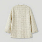Back view of a textured beige jacket on a light gray background