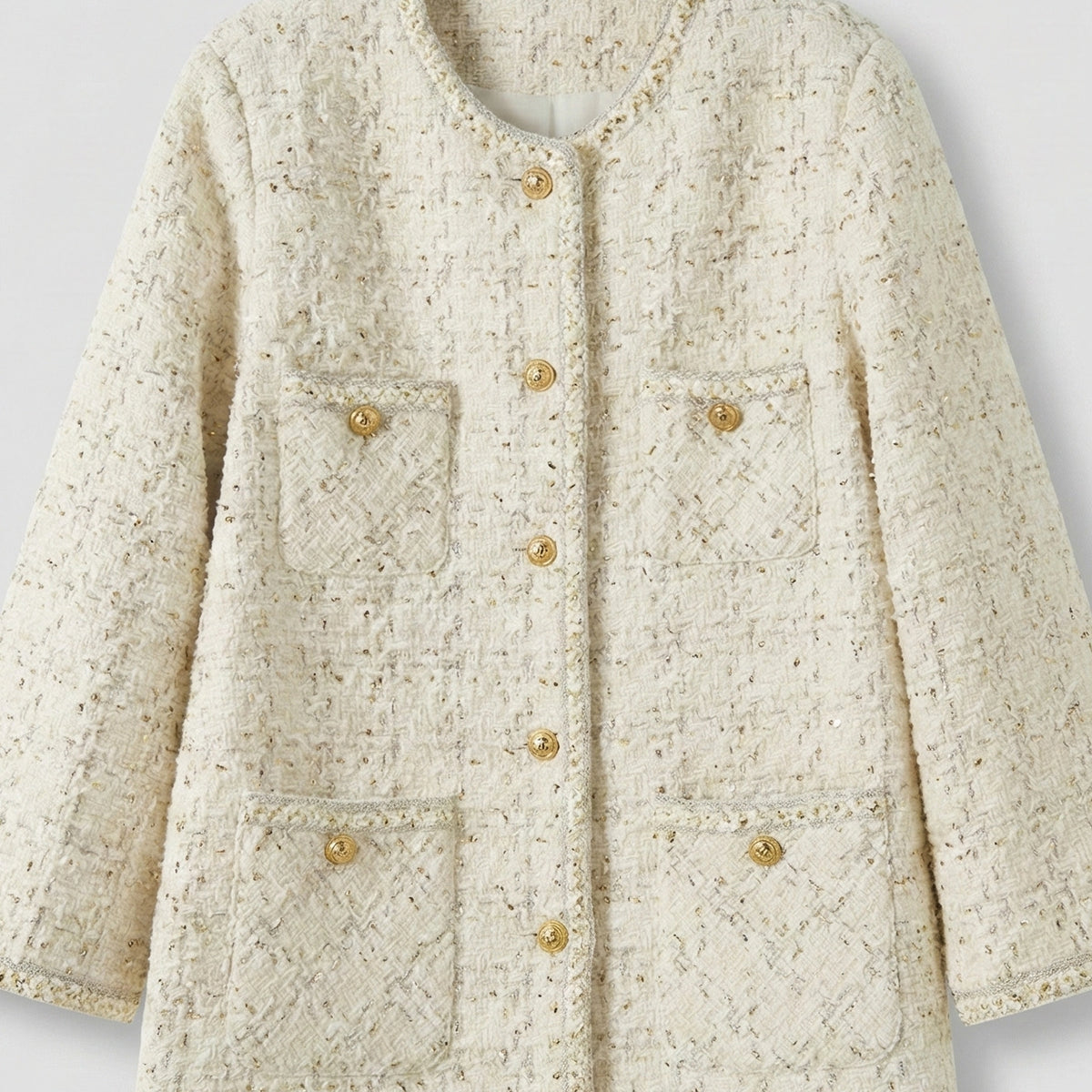 Beige textured jacket with gold buttons on a light gray background