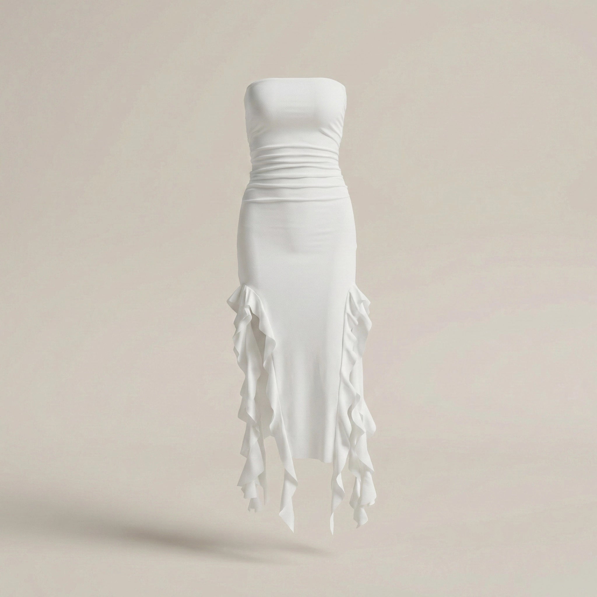 White strapless dress with fringe details on a beige background