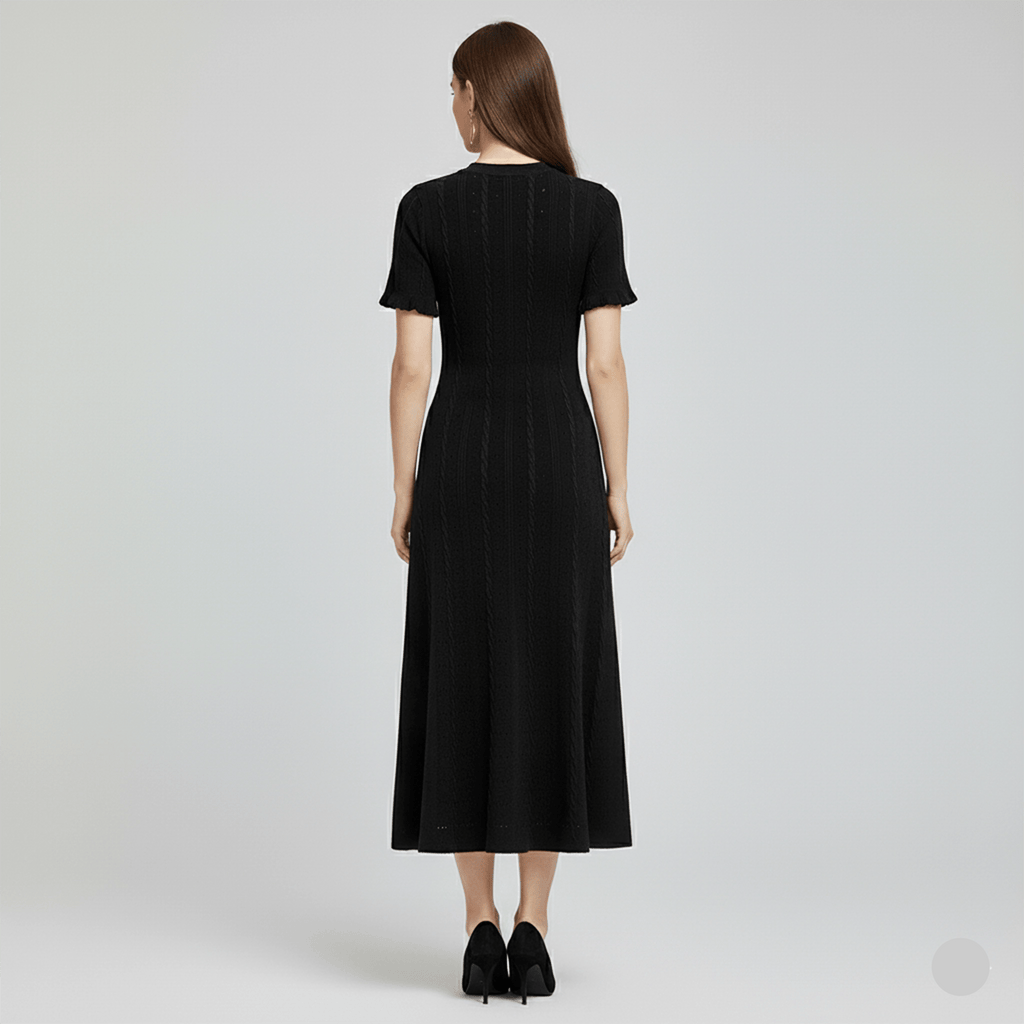 Woman wearing a black dress from behind on a light gray background