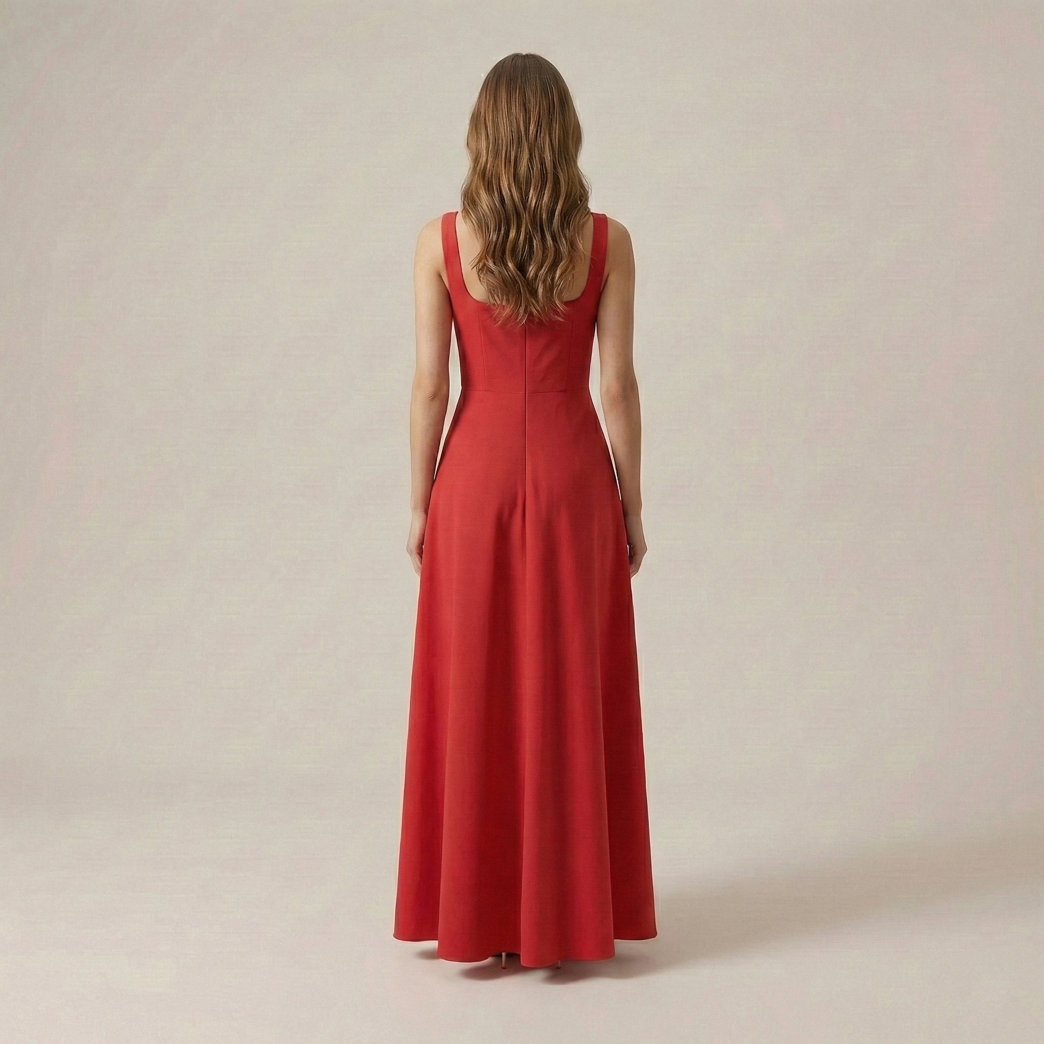 Woman wearing a red dress against a plain background