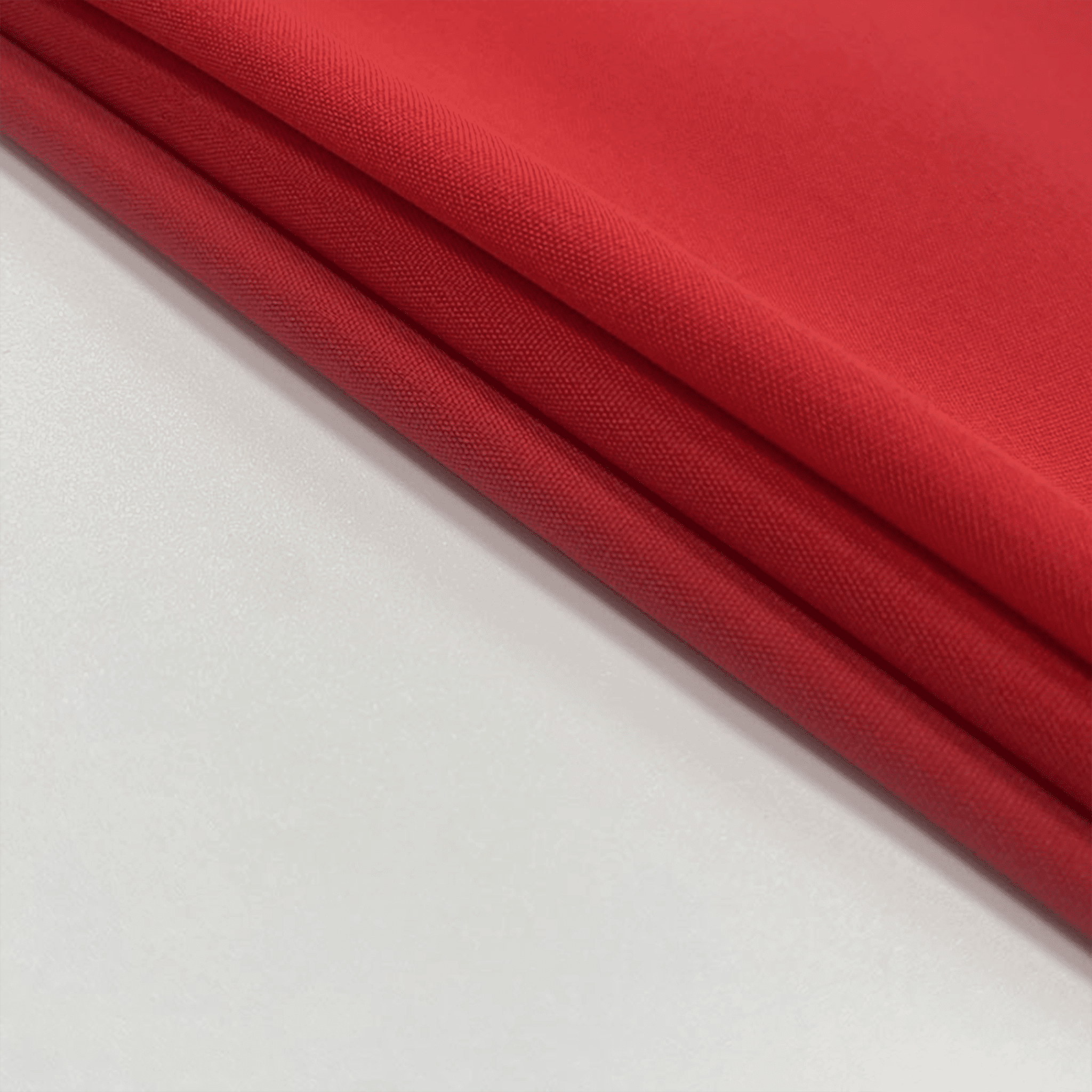 Stack of red fabric on a light gray background